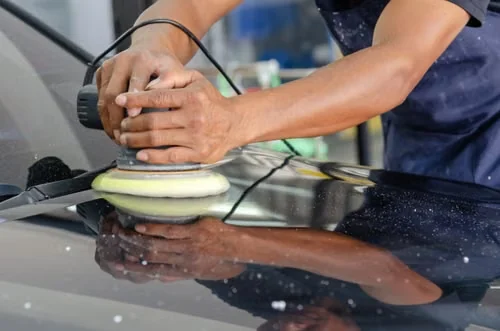 Close-up of final machine polishing on automotive paint